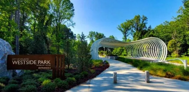 a view of a street with benches and a garden