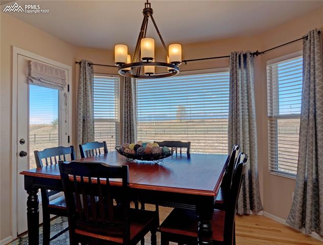 11601 Rio Secco Road Peyton, CO 80831 - Photo 19 of 36 Dining nook with wood floors and Mountain Views