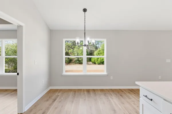 a view of a room with window wooden floor and entryway
