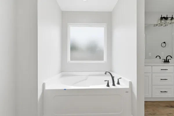 a bathroom with a bathtub and a window