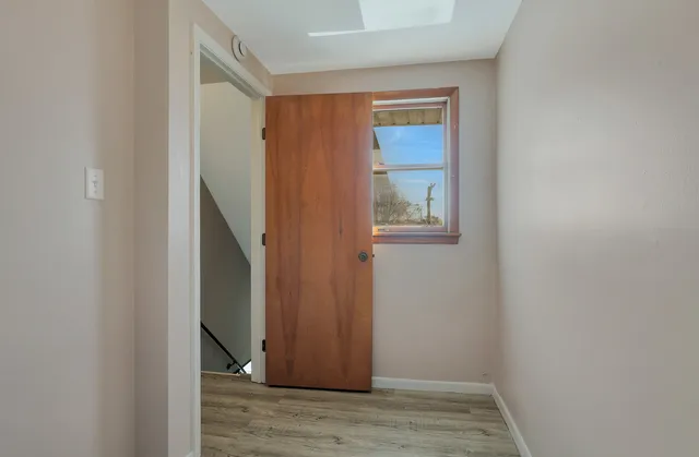 a view of an entryway with wooden floor