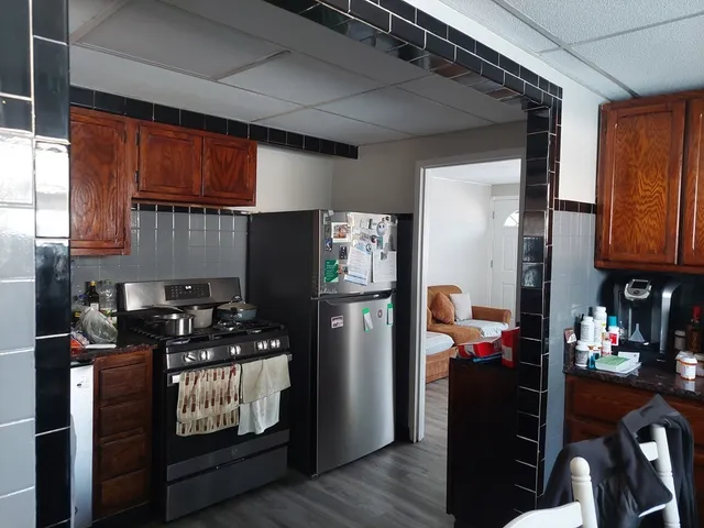 a kitchen with stainless steel appliances granite countertop a refrigerator stove and sink