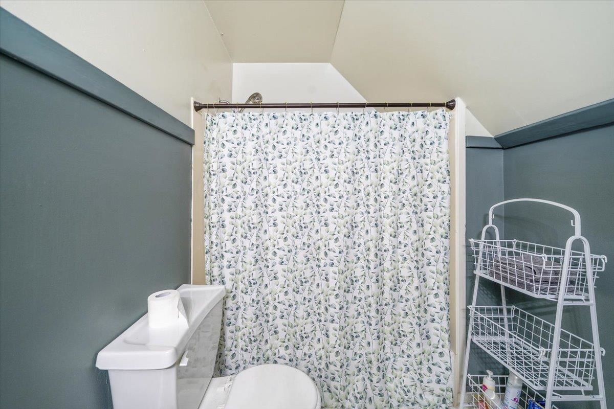 7226 Cedar Road Bartlett, TN 38135 - Photo 24 of 29 a bathroom with a toilet and a shower curtain