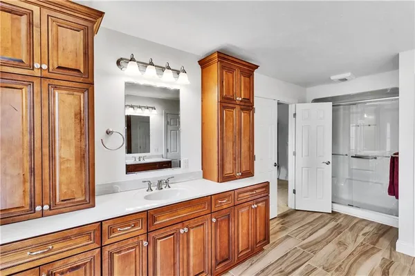 a bathroom with a double vanity sink a mirror and a bathtub