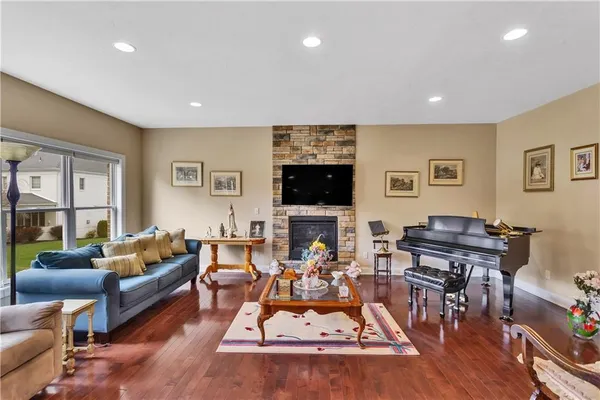 a living room with furniture a flat screen tv and a table