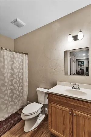 a bathroom with a sink a toilet and a mirror