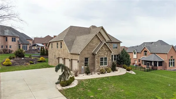 a front view of a house with a garden and pathway