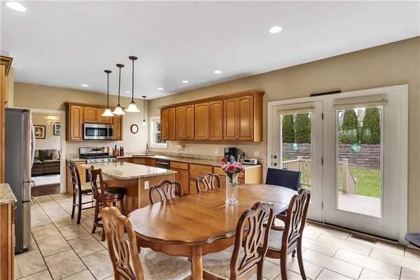 a large dining space with furniture window and wooden floor