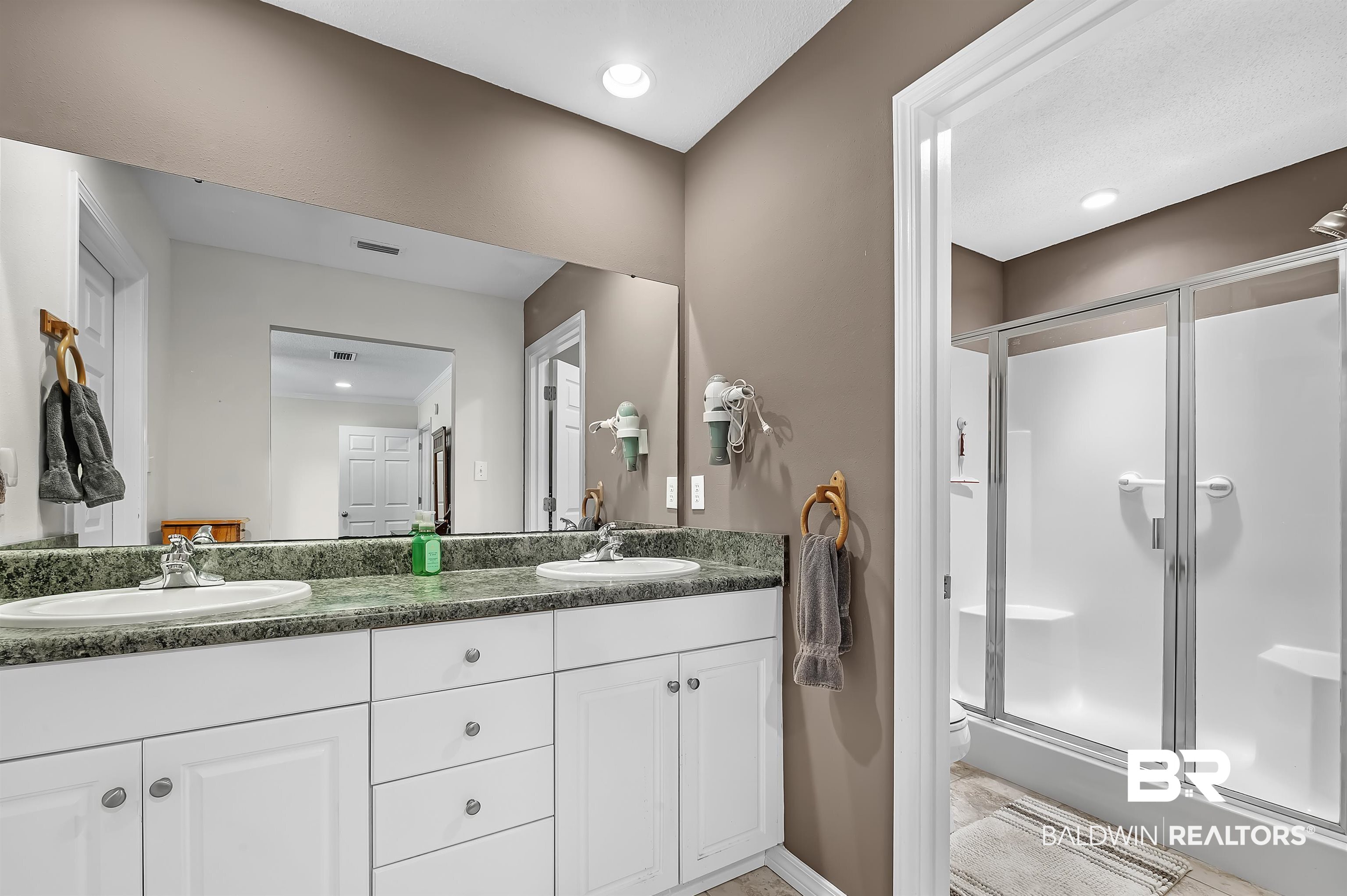 9908 Clarke Ridge Road Foley, AL 36535 - Photo 41 of 56 Bathroom featuring a sink, a stall shower, and visible vents