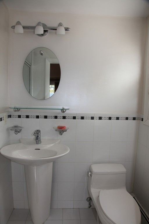 155 Noanett Road Needham, MA 02494 - Photo 7 of 18 a bathroom with a sink a toilet and mirror