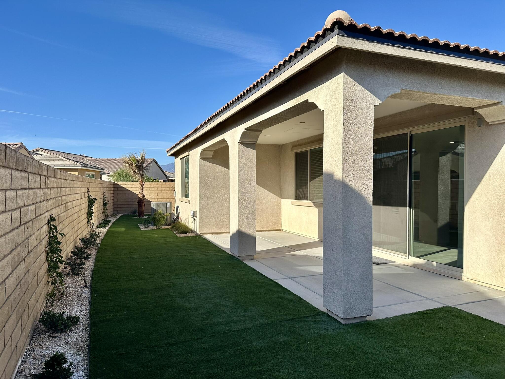 78879 Fortuna Place Palm Desert, CA 92211 - Photo 21 of 25 a front view of a house with a yard