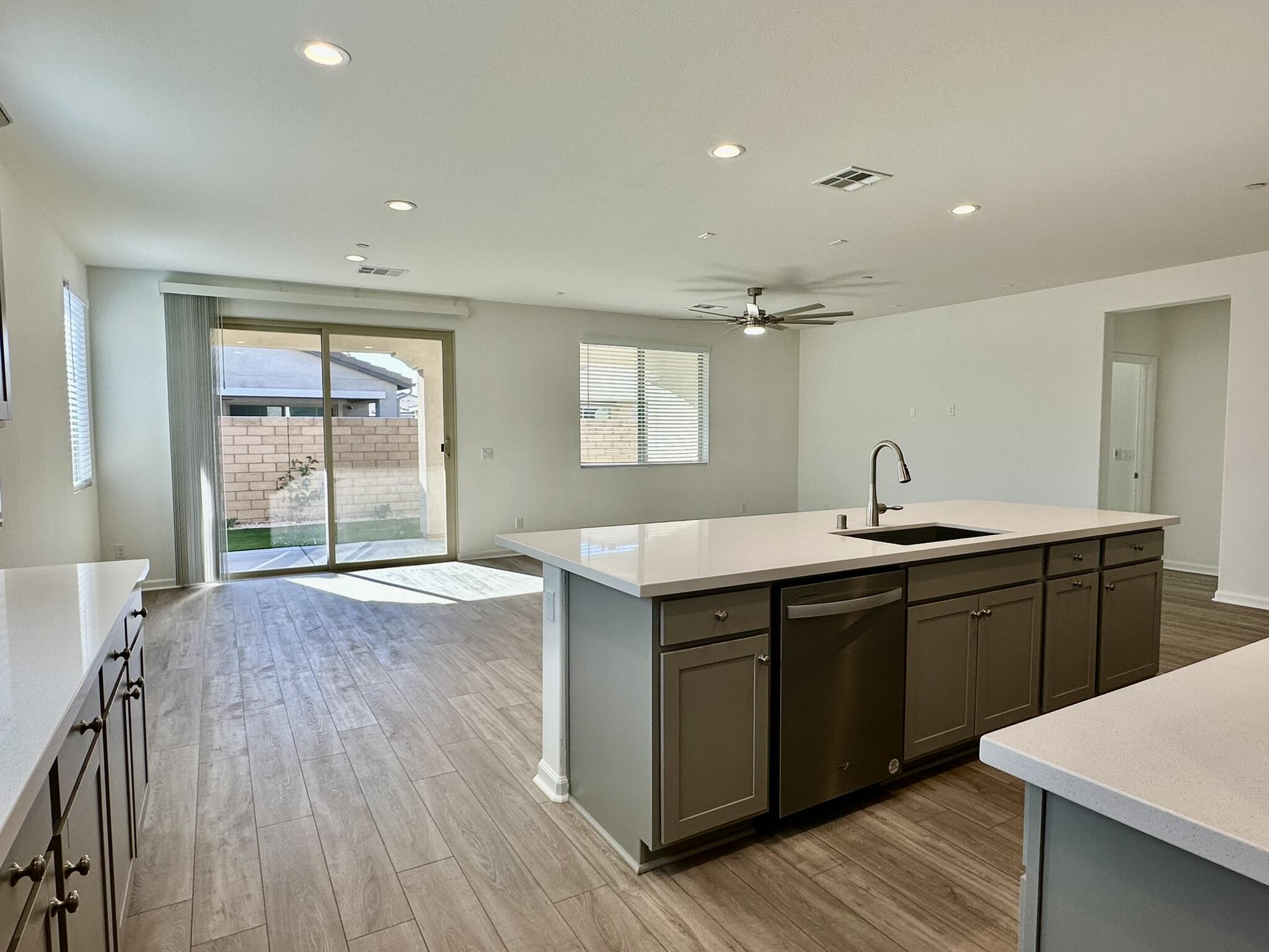 78879 Fortuna Place Palm Desert, CA 92211 - Photo 5 of 25 a kitchen with a sink and wooden cabinets