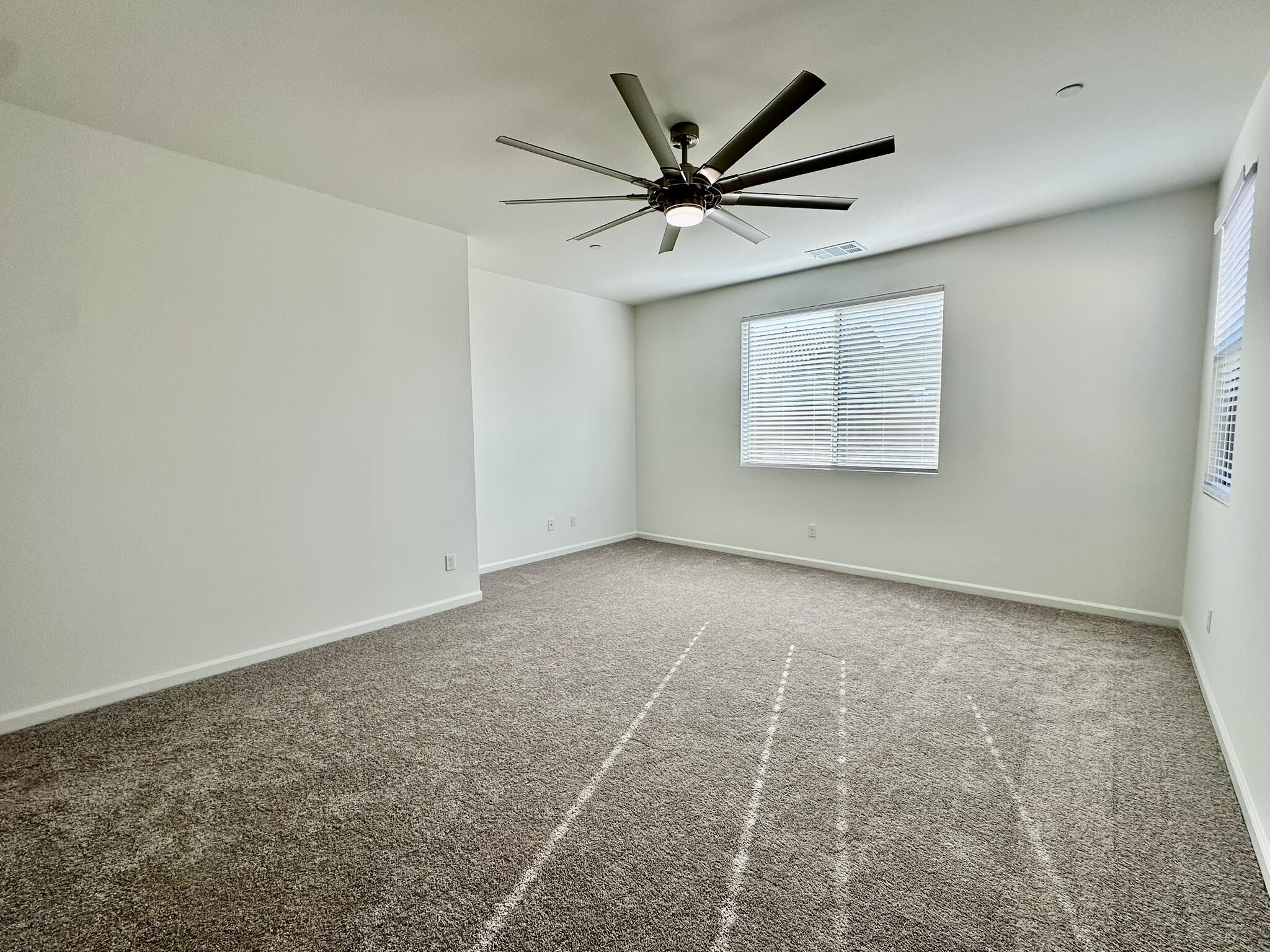 78879 Fortuna Place Palm Desert, CA 92211 - Photo 6 of 25 an empty room with a window and a fan