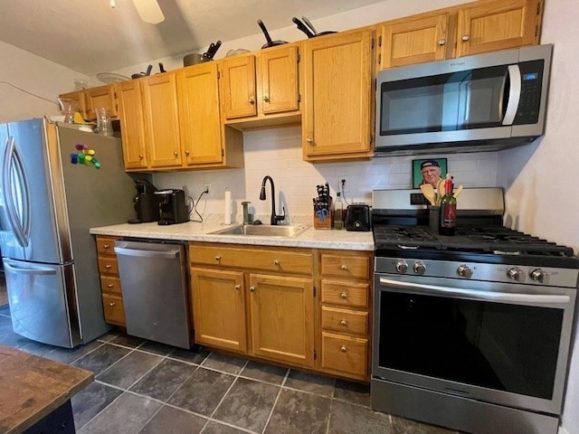 a kitchen with stainless steel appliances granite countertop a stove microwave and refrigerator