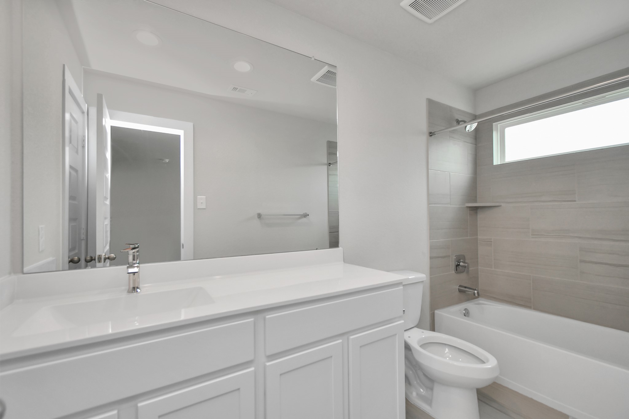 15111 Statice Trail Houston, TX 77044 - Photo 29 of 35 Bath/shower combo surrounded by tasteful tile in this secondary bath. Sample photo of completed home with similar floor plan. Actual colors and selections may vary.