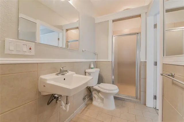 a bathroom with a sink toilet and a mirror