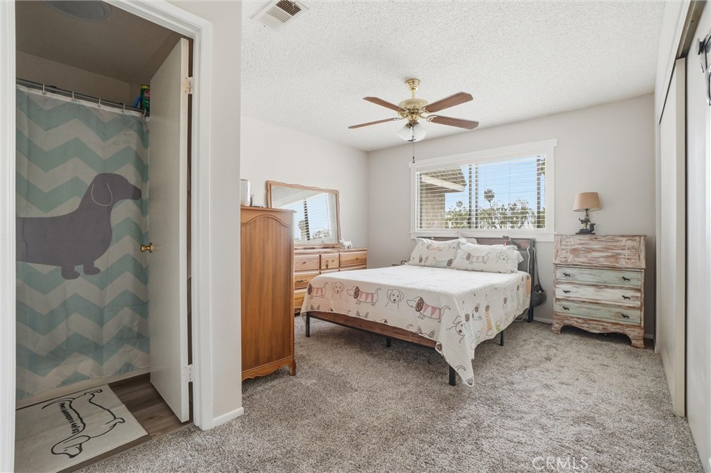 904 Cornwall Drive Anaheim, CA 92804 - Photo 14 of 42 a spacious bedroom with a bed and a walk in closet