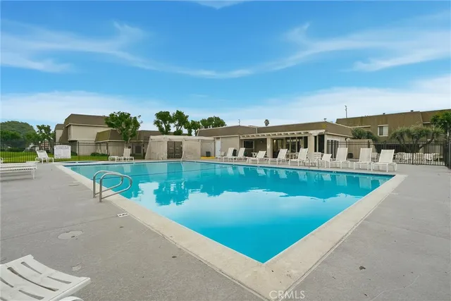 a view of an swimming pool with a yard and seating area