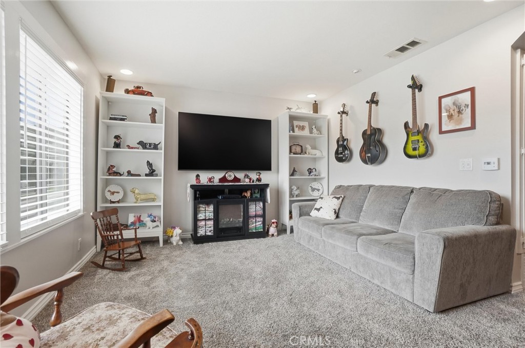 904 Cornwall Drive Anaheim, CA 92804 - Photo 6 of 42 a living room with fireplace furniture and a flat screen tv