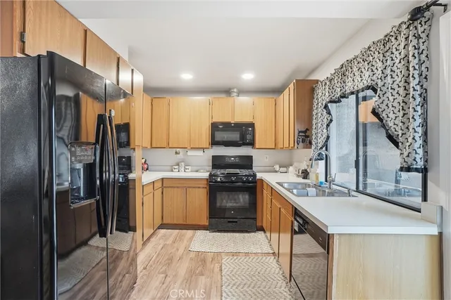 a view of a dining room with furniture and a kitchen
