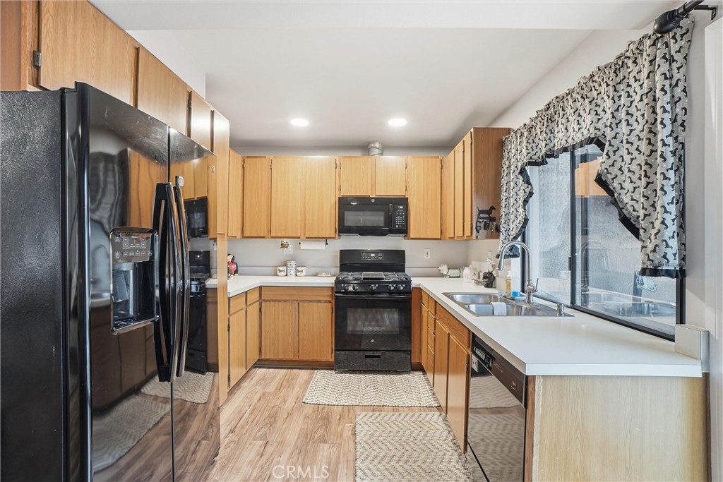 904 Cornwall Drive Anaheim, CA 92804 - Photo 9 of 42 a kitchen with stainless steel appliances granite countertop a refrigerator stove and sink