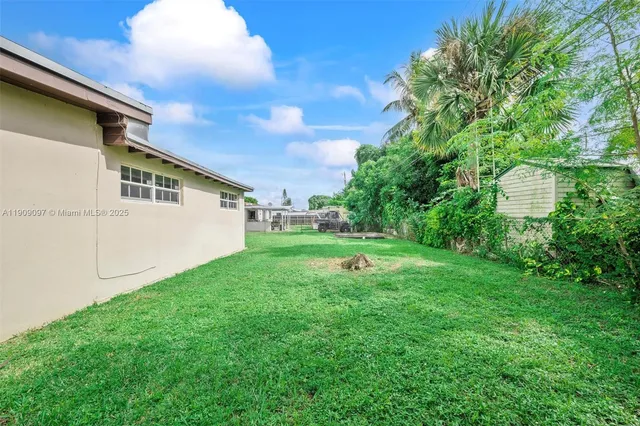 a view of a backyard with plants and a garden