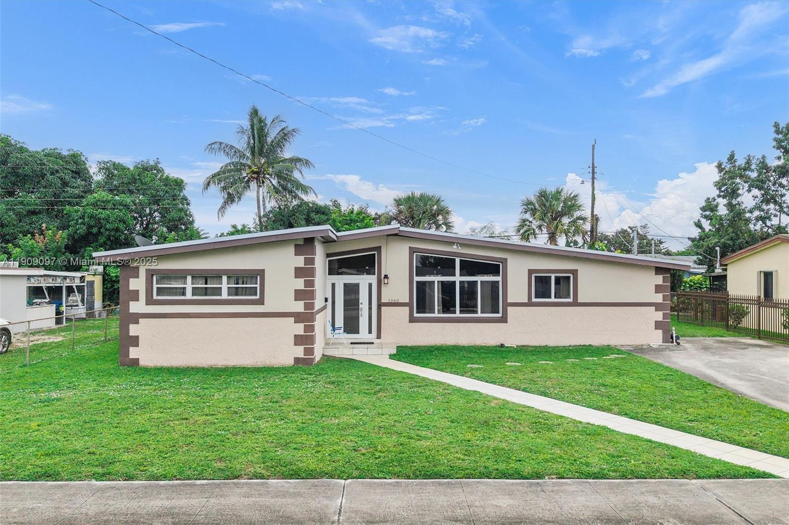 1960 Northwest 187th Street Miami Gardens, FL 33056 - Photo 17 of 23 a front view of house with yard and green space