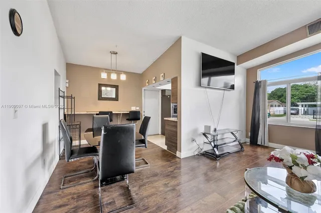 a view of a dining room with furniture window and outside view