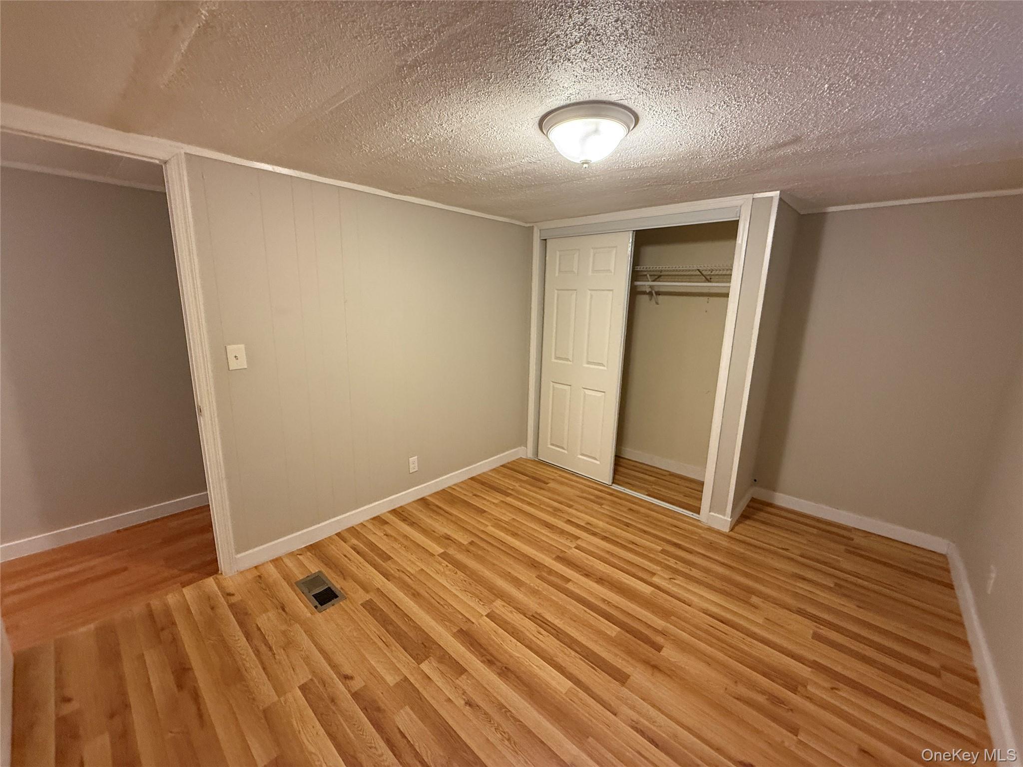 412 Cologne Avenue Wallkill, NY 12589 - Photo 12 of 16 a view of an empty room with wooden floor
