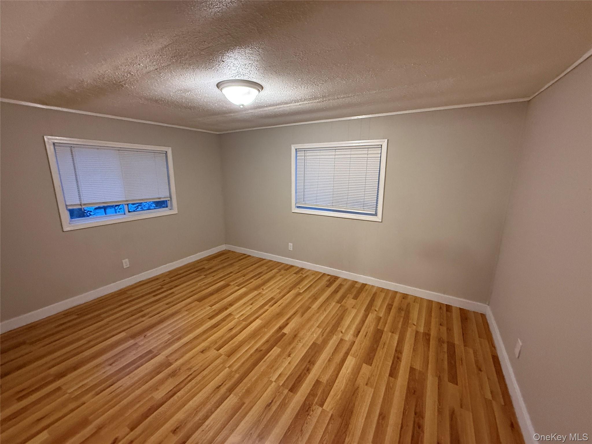 412 Cologne Avenue Wallkill, NY 12589 - Photo 13 of 16 a view of a room with wooden floor and windows