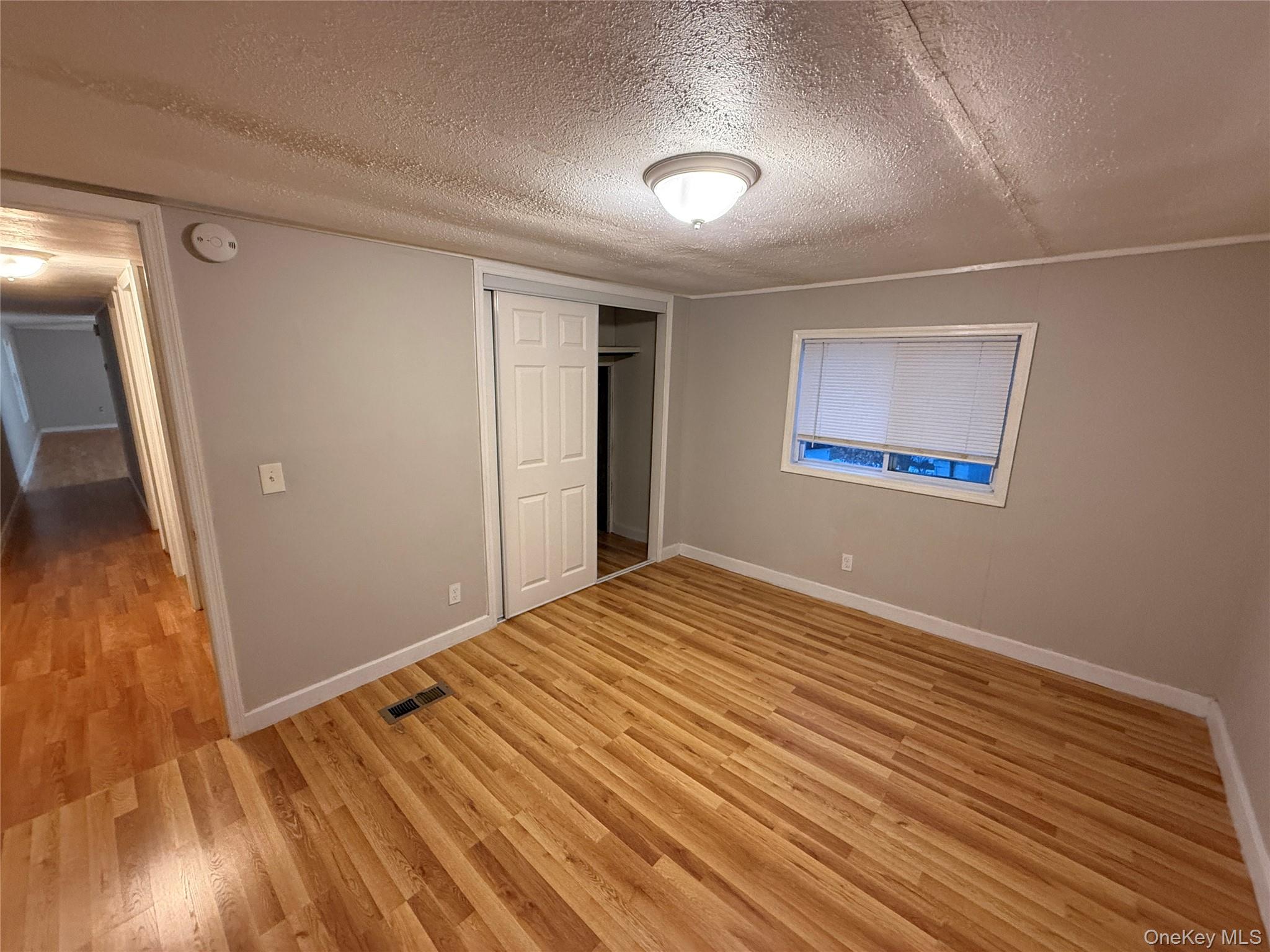 412 Cologne Avenue Wallkill, NY 12589 - Photo 14 of 16 a view of empty room with wooden floor