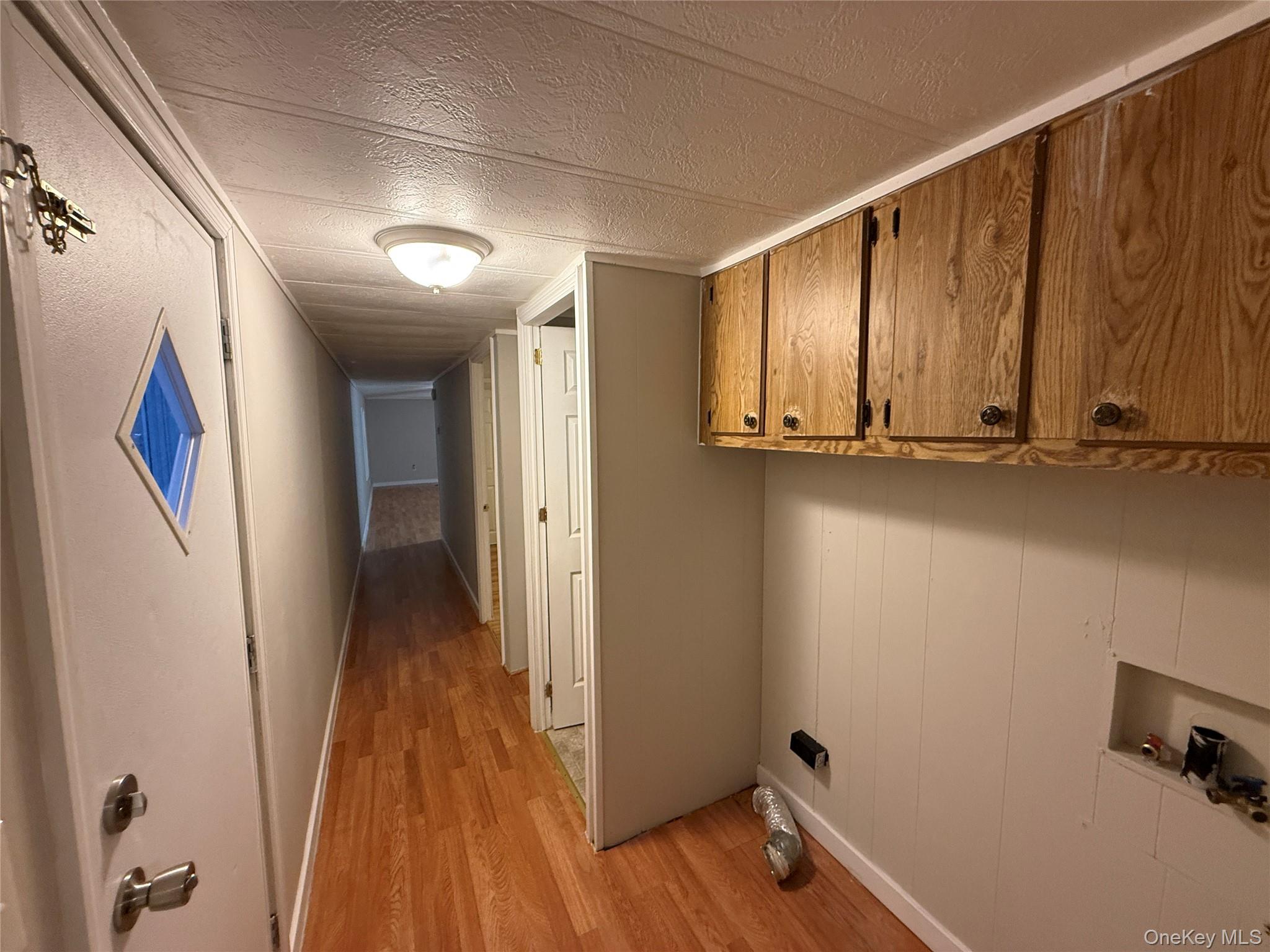 412 Cologne Avenue Wallkill, NY 12589 - Photo 15 of 16 a view of a hallway with wooden floor and staircase