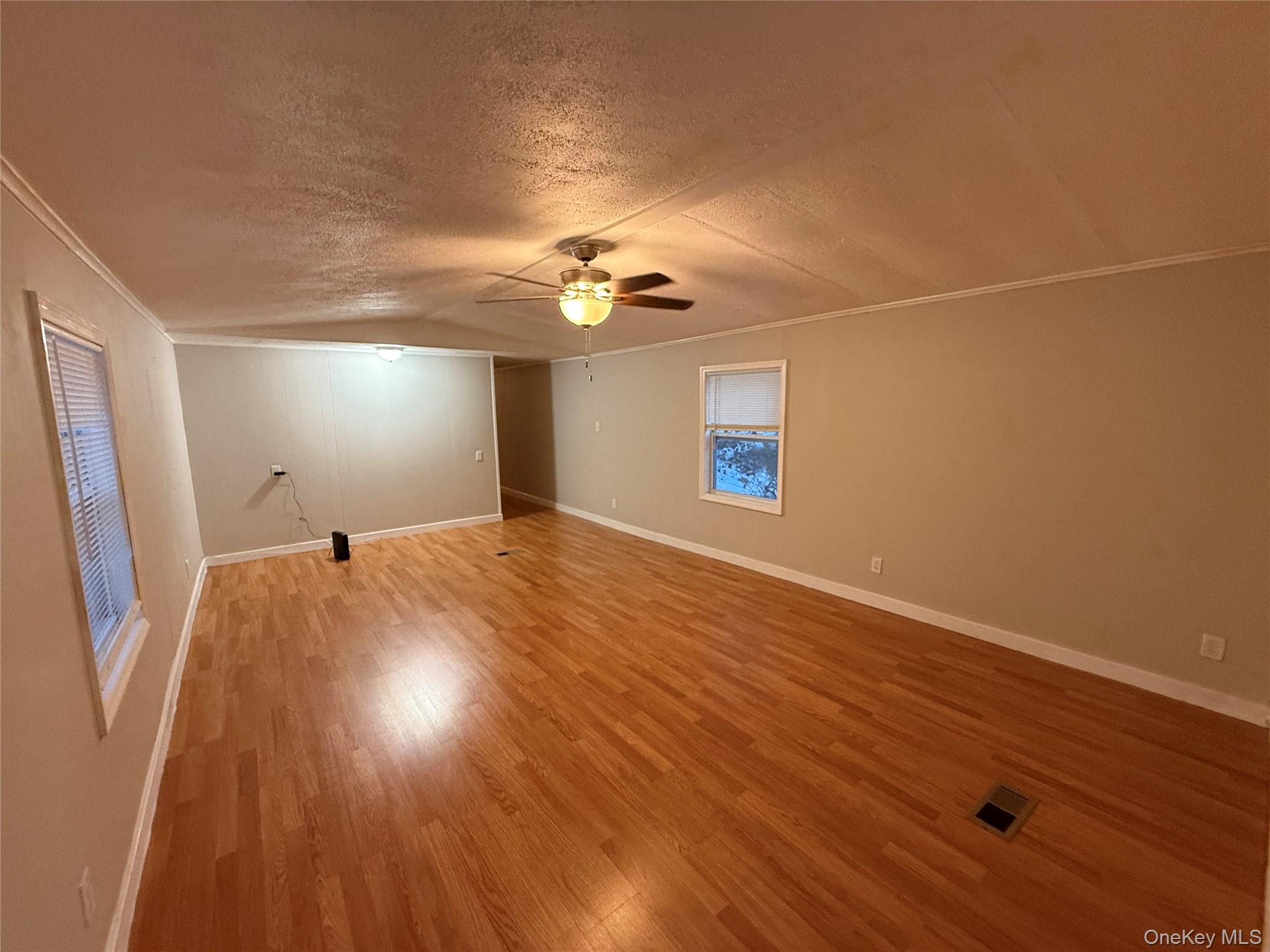 412 Cologne Avenue Wallkill, NY 12589 - Photo 7 of 16 wooden floor in an empty room with a window