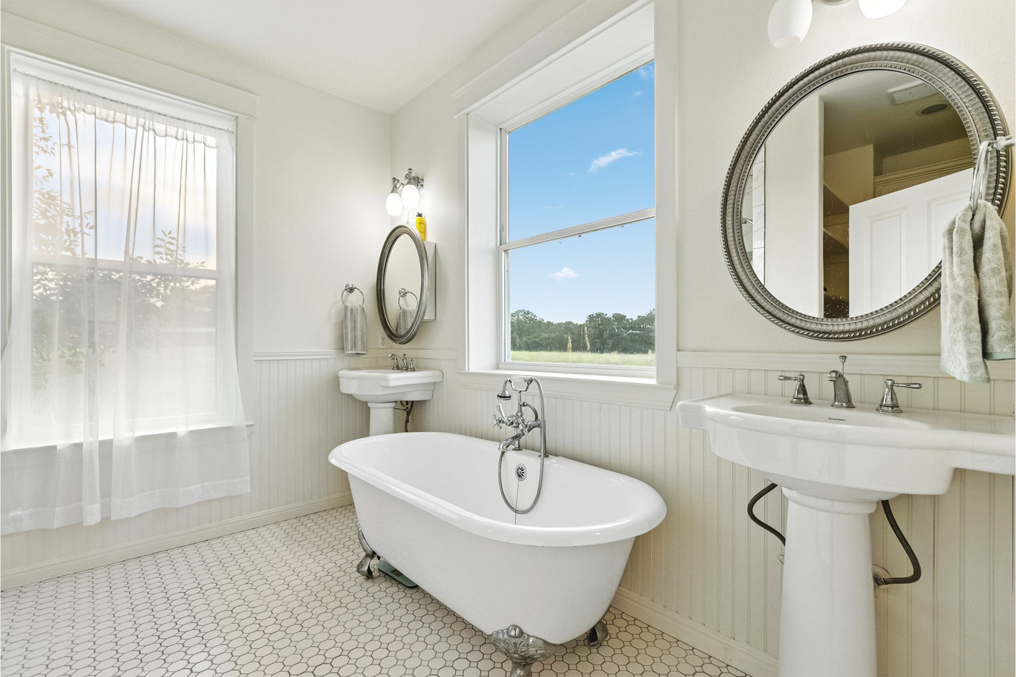 498 North County Line Road Elgin, TX 78621 - Photo 10 of 40 Bathroom featuring a freestanding tub and a wainscoted wall