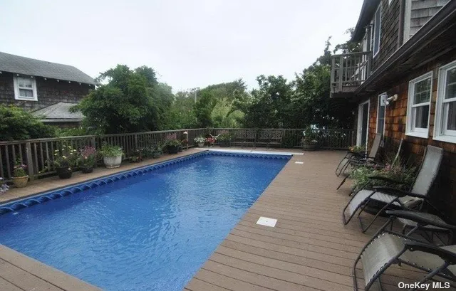 swimming pool view with plants and seating space