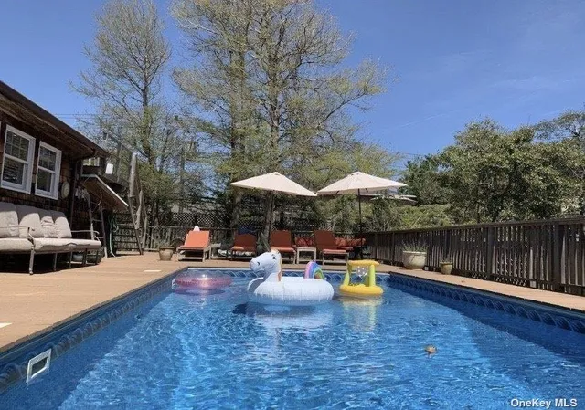 a wooden bench sitting in front of a building