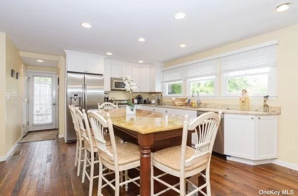a dining table with chairs and wooden floor