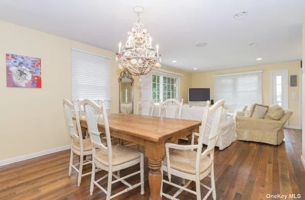 a view of a dining room with furniture wooden floor and chandelier