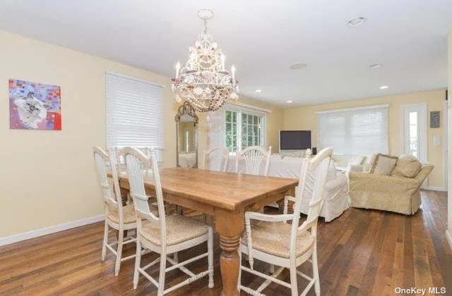 a view of a dining room with furniture wooden floor and chandelier