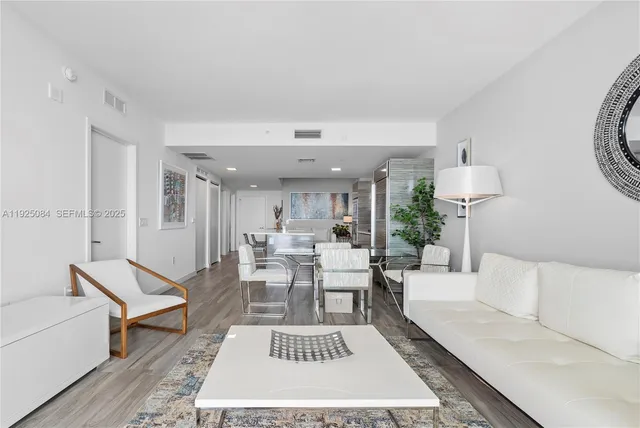 a living room with furniture a rug and a table