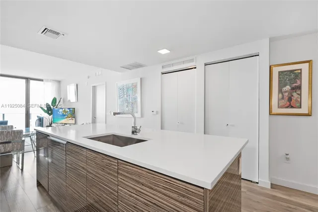a kitchen with a table chairs and wooden floor
