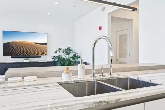 a view of kitchen sink and living room