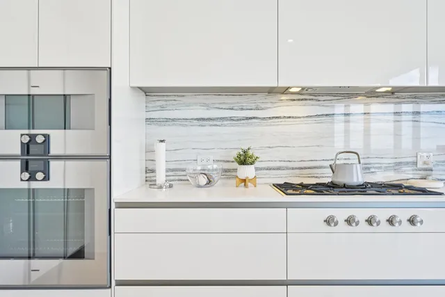 a kitchen with a refrigerator and cabinets