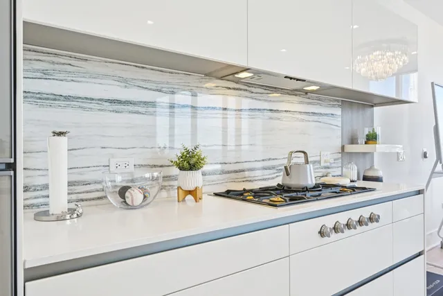 a kitchen with a stove and a white cabinets