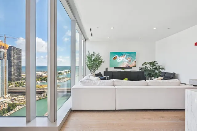 a living room with a large window and a flat screen tv