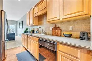 a kitchen with stainless steel appliances granite countertop a sink and cabinets