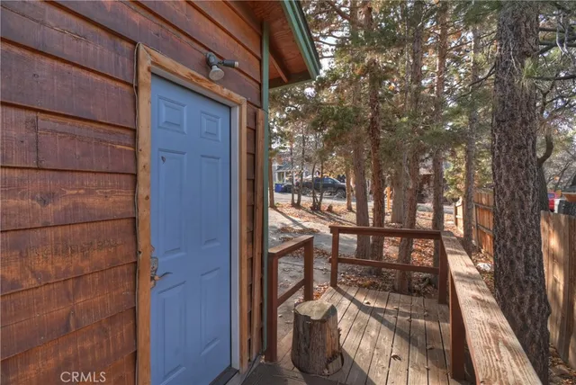 a kitchen with stainless steel appliances granite countertop a refrigerator and a couch