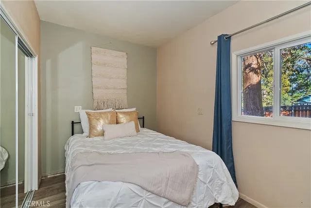 a bedroom with a bed and glass door
