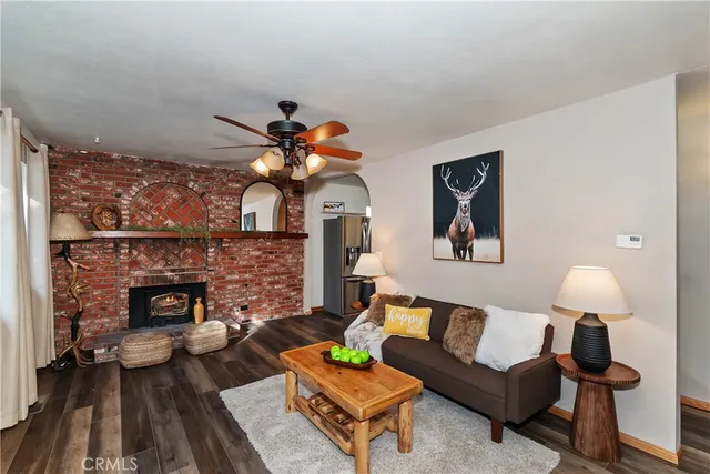 a living room with furniture a fireplace and a table