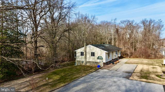 714-720 Harding Highway Carneys Point, NJ 08069 - Photo 8 of 40 a white house covered with tall trees